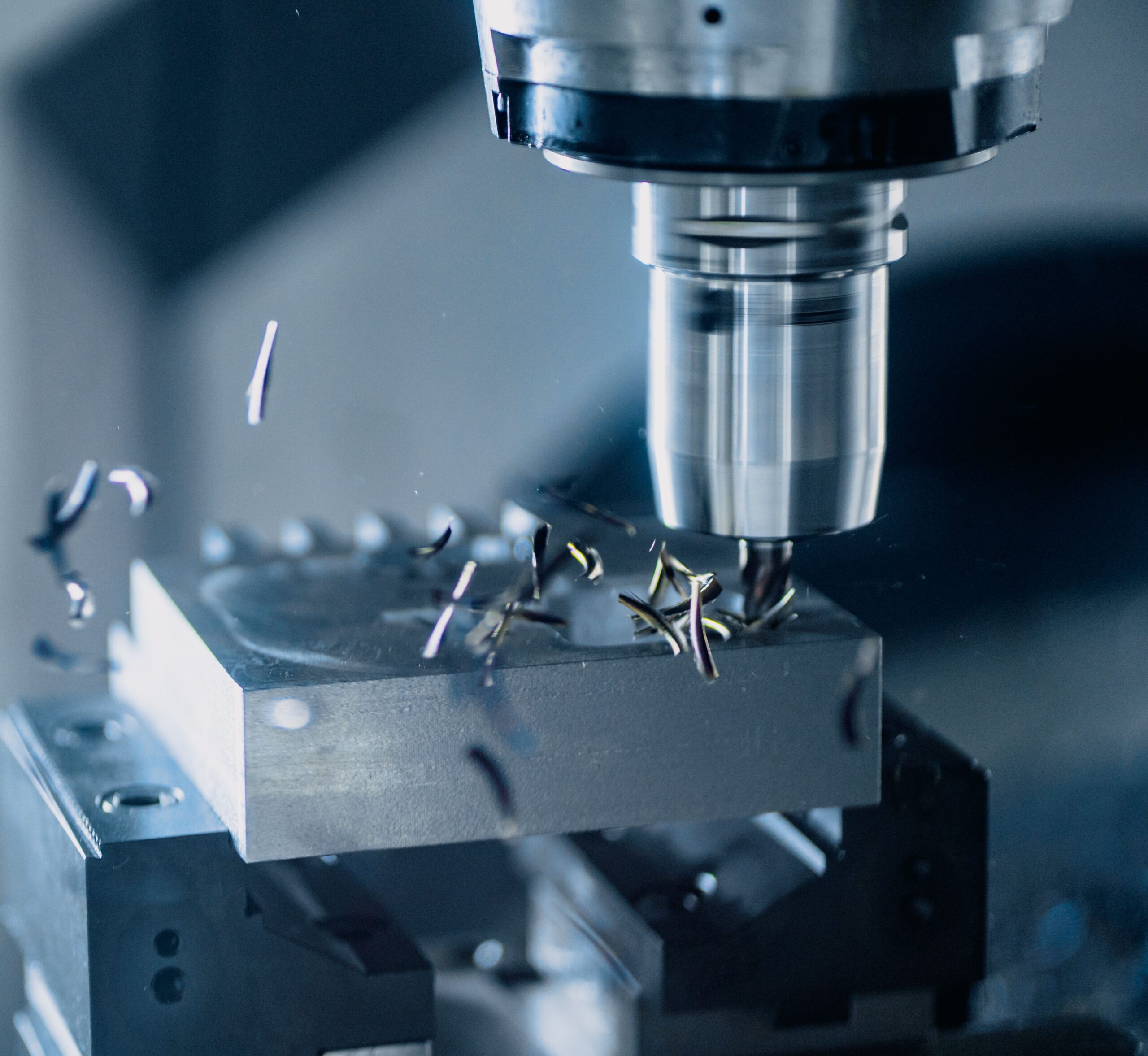 CNC milling machine precisely cutting a metal component for a screen prop
